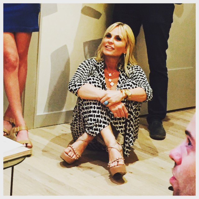 Cori completely at home chatting with guests on the floor.